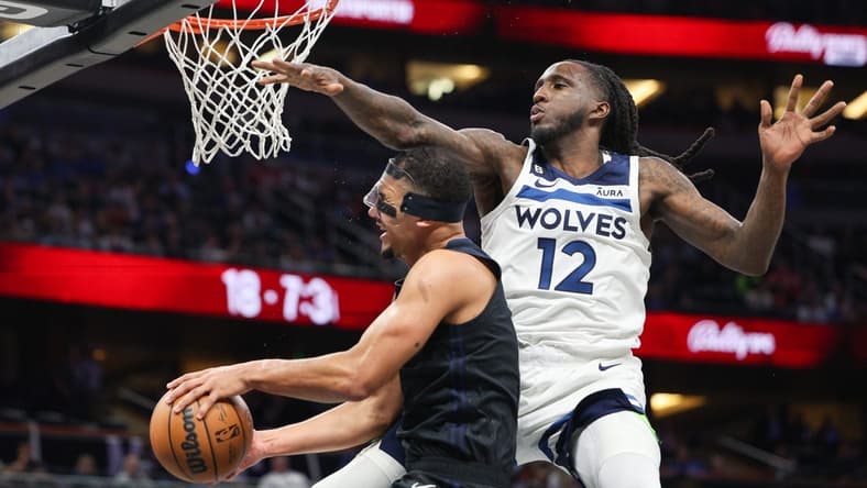 Nov 15, 2022; Tampa, Florida, USA; Minnesota Timberwolves forward Taurean Prince (12) is called for a flagrant foul on Orlando Magic guard Jalen Suggs (4) in the third quarter at Amalie Arena. Mandatory Credit: Nathan Ray Seebeck-USA TODAY Sports