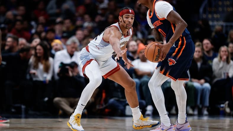 Nov 16, 2022; Denver, Colorado, USA; New York Knicks forward Cam Reddish (0) controls the ball as Denver Nuggets forward Zeke Nnaji (22) defends in the second quarter at Ball Arena. Mandatory Credit: Isaiah J. Downing-USA TODAY Sports