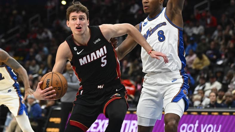 Nov 18, 2022; Washington, District of Columbia, USA; Miami Heat forward Nikola Jovic (5) looks to pass as Washington Wizards forward Rui Hachimura (8) defends during the first half at Capital One Arena. Mandatory Credit: Brad Mills-USA TODAY Sports