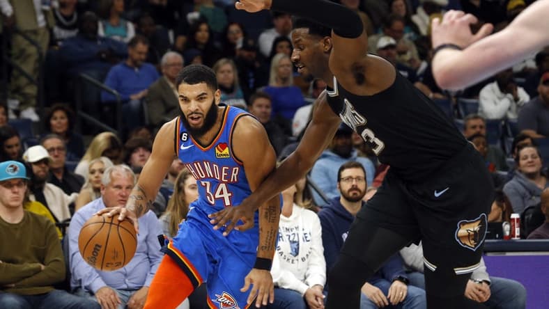 Nov 18, 2022; Memphis, Tennessee, USA; Oklahoma City Thunder forward Kenrich Williams (34) drives to the basket as Memphis Grizzlies forward Jaren Jackson Jr. (13) defends during the second quarter at FedExForum. Mandatory Credit: Petre Thomas-USA TODAY Sports