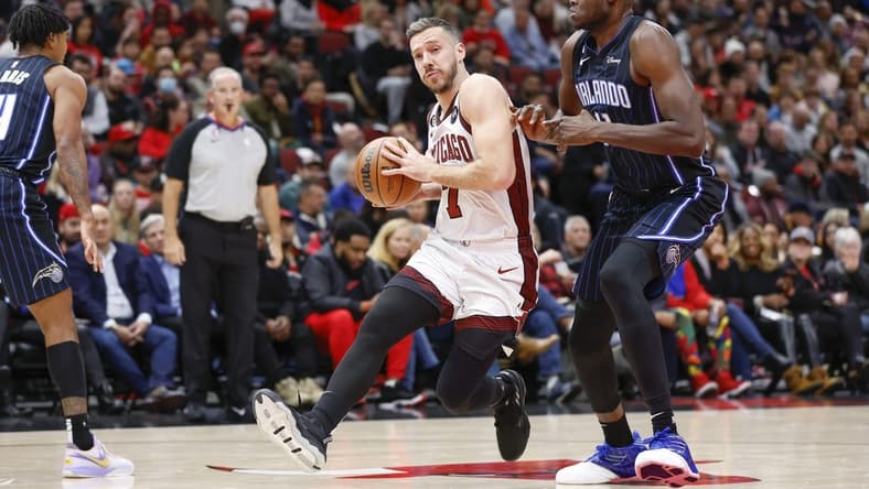 Nov 18, 2022; Chicago, Illinois, USA; Chicago Bulls guard Goran Dragic (7) drives to the basket against Orlando Magic center Mo Bamba (11) during the first half at United Center. Mandatory Credit: Kamil Krzaczynski-USA TODAY Sports