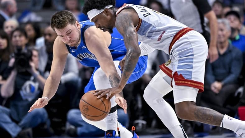 Nov 18, 2022; Dallas, Texas, USA; Dallas Mavericks guard Luka Doncic (77) and Denver Nuggets guard Kentavious Caldwell-Pope (5) battle for the loose ball during the second quarter at the American Airlines Center. Mandatory Credit: Jerome Miron-USA TODAY Sports