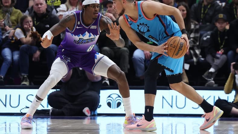 Nov 18, 2022; Salt Lake City, Utah, USA; Phoenix Suns guard Devin Booker (1) looks to drive the ball against Utah Jazz forward Jarred Vanderbilt (8) in the second quarter at Vivint Arena. Mandatory Credit: Rob Gray-USA TODAY Sports