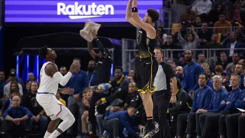 Nov 18, 2022; San Francisco, California, USA; Golden State Warriors guard Klay Thompson (11) shoots a 3-point basket over New York Knicks guard RJ Barrett (9) during the first quarter at Chase Center. Mandatory Credit: D. Ross Cameron-USA TODAY Sports