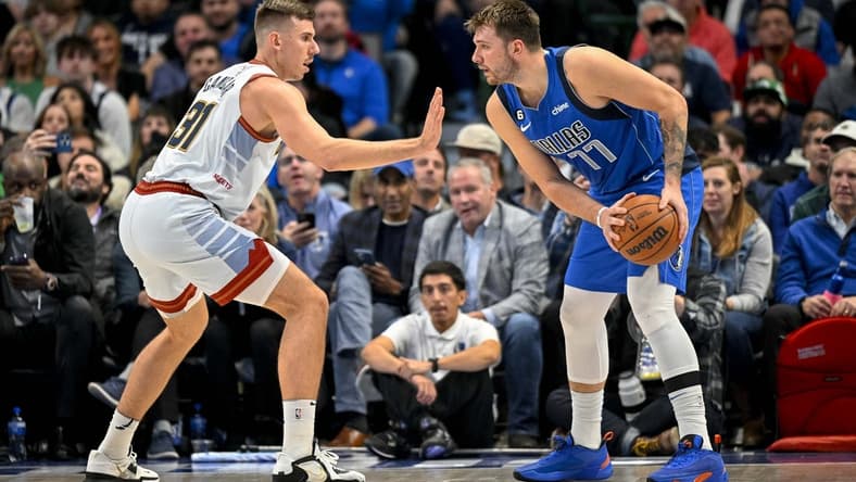 Nov 18, 2022; Dallas, Texas, USA; Denver Nuggets forward Vlatko Cancar (31) defends against Dallas Mavericks guard Luka Doncic (77) during the second half at the American Airlines Center. Mandatory Credit: Jerome Miron-USA TODAY Sports