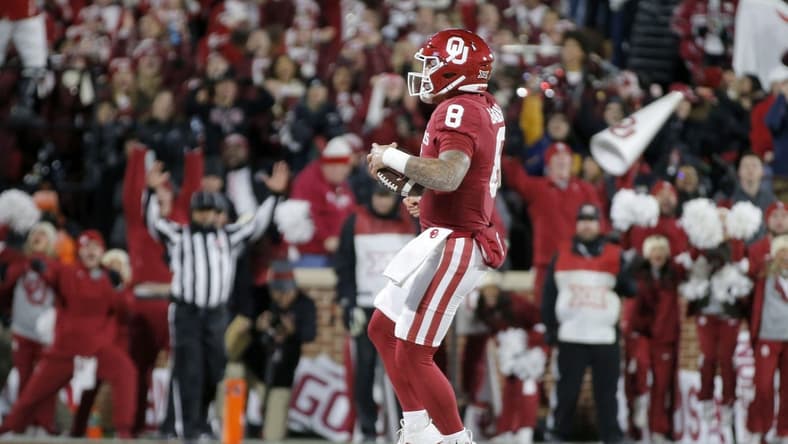 Nov 19, 2022; Norman, Oklahoma, USA; Oklahoma Sooners quarterback Dillon Gabriel (8) runs for a touchdown against the Oklahoma State Cowboys during a game at Gaylord Family-Oklahoma Memorial Stadium. Mandatory Credit: Bryan Terry-USA TODAY Sports