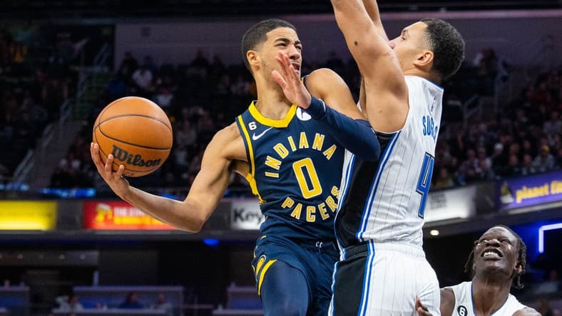 Nov 19, 2022; Indianapolis, Indiana, USA; Indiana Pacers guard Tyrese Haliburton (0) shoots the ball against Orlando Magic guard Jalen Suggs (4) in the second half at Gainbridge Fieldhouse. Mandatory Credit: Trevor Ruszkowski-USA TODAY Sports