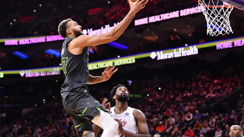 Nov 19, 2022; Philadelphia, Pennsylvania, USA; Minnesota Timberwolves center Rudy Gobert (27) shoots over Philadelphia 76ers center Joel Embiid (21) in the second quarter at Wells Fargo Center. Mandatory Credit: Kyle Ross-USA TODAY Sports