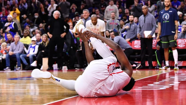 Nov 19, 2022; Philadelphia, Pennsylvania, USA; Philadelphia 76ers center Joel Embiid (21) grabs his ankle after falling against the Minnesota Timberwolves in the fourth quarter at Wells Fargo Center. Mandatory Credit: Kyle Ross-USA TODAY Sports