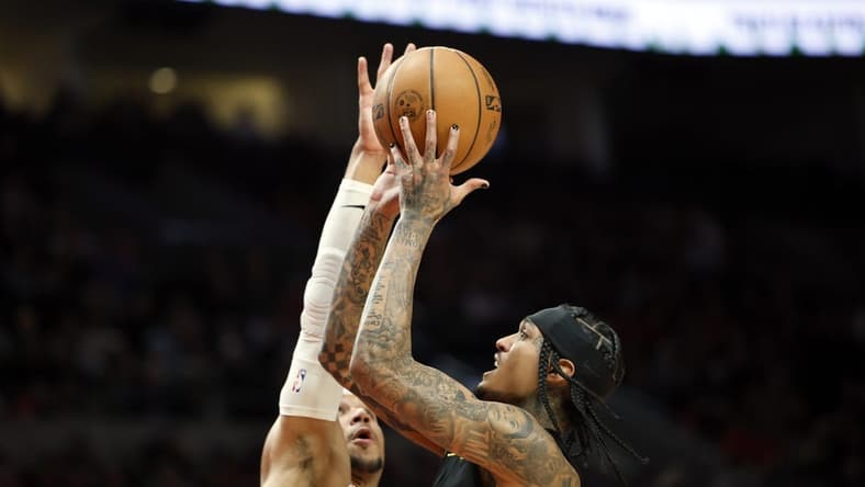 Nov 19, 2022; Portland, Oregon, USA; Utah Jazz point guard Jordan Clarkson (00) shoots the ball against Portland Trail Blazers shooting guard Josh Hart (11, left) during the first half at Moda Center. Mandatory Credit: Soobum Im-USA TODAY Sports