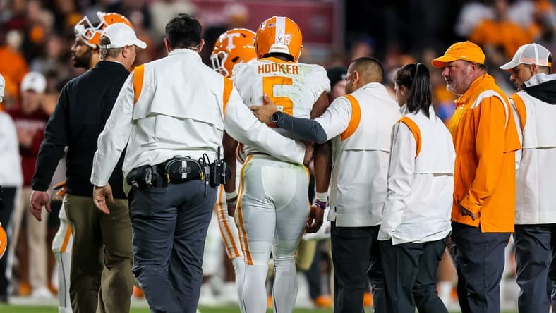 Nov 19, 2022; Columbia, South Carolina, USA; Tennessee Volunteers quarterback Hendon Hooker (5) is assisted off the field after suffering an apparent injury against the South Carolina Gamecocks in the second half at Williams-Brice Stadium. Mandatory Credit: Jeff Blake-USA TODAY Sports