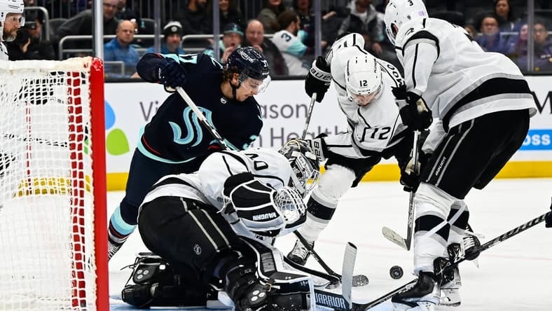 Nov 19, 2022; Seattle, Washington, USA; Los Angeles Kings goaltender Cal Petersen (40) defends the goal as Seattle Kraken center Jaden Schwartz (17) and Los Angeles Kings left wing Trevor Moore (12) fight for the puck during the third period at Climate Pledge Arena. Seattle won 3-2. Mandatory Credit: Steven Bisig-USA TODAY Sports