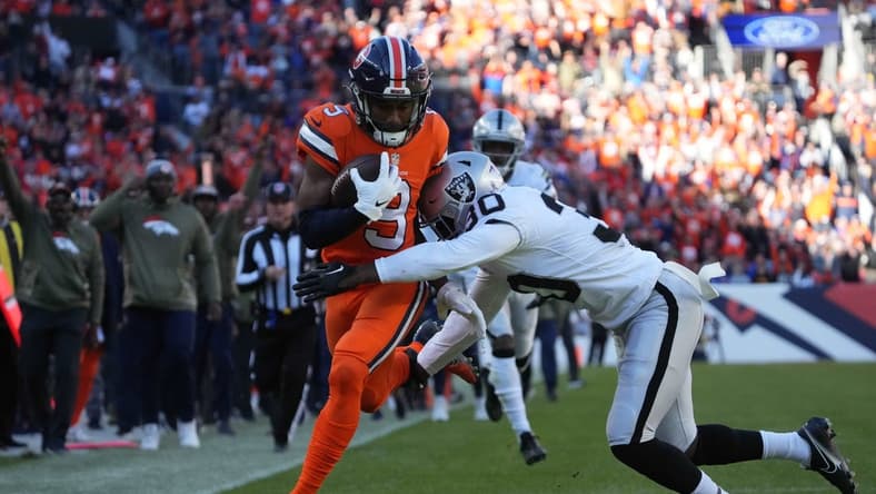 Nov 20, 2022; Denver, Colorado, USA; Las Vegas Raiders safety Duron Harmon (30) tackles Denver Broncos wide receiver Kendall Hinton (9) in the first quarter at Empower Field at Mile High. Mandatory Credit: Ron Chenoy-USA TODAY Sports
