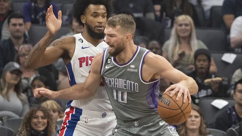 November 20, 2022; Sacramento, California, USA; Sacramento Kings forward Domantas Sabonis (10) dribbles the basketball against Detroit Pistons forward Marvin Bagley III (35) during the first quarter at Golden 1 Center. Mandatory Credit: Kyle Terada-USA TODAY Sports
