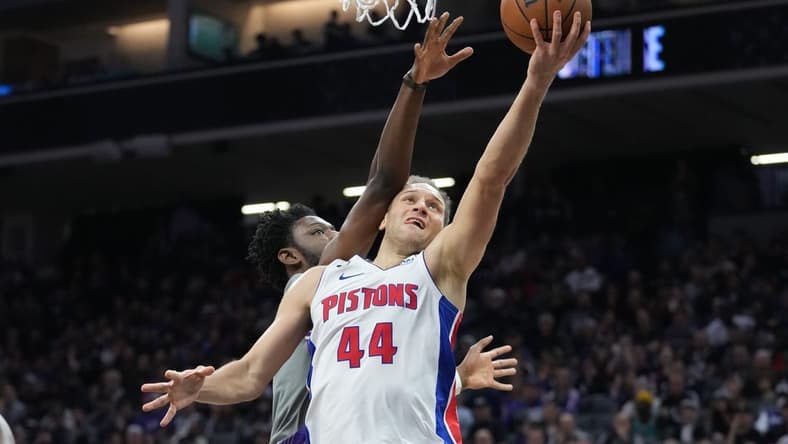 November 20, 2022; Sacramento, California, USA; Detroit Pistons forward Bojan Bogdanovic (44) shoots the basketball against Sacramento Kings forward Chimezie Metu (7) during the second quarter at Golden 1 Center. Mandatory Credit: Kyle Terada-USA TODAY Sports