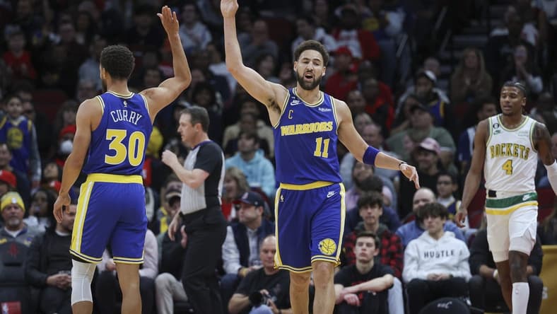 Nov 20, 2022; Houston, Texas, USA; Golden State Warriors guard Klay Thompson (11) and guard Stephen Curry (30) celebrate after a play during the first quarter against the Houston Rockets at Toyota Center. Mandatory Credit: Troy Taormina-USA TODAY Sports