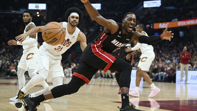 Nov 20, 2022; Cleveland, Ohio, USA; Miami Heat center Bam Adebayo (13) loses control of the ball as Cleveland Cavaliers center Jarrett Allen (31) defends during the first half at Rocket Mortgage FieldHouse. Mandatory Credit: Ken Blaze-USA TODAY Sports