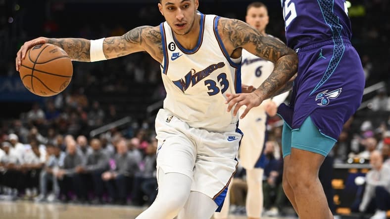 Nov 20, 2022; Washington, District of Columbia, USA; Washington Wizards forward Kyle Kuzma (33) dribbles as Charlotte Hornets forward P.J. Washington (25) defends during the first half at Capital One Arena. Mandatory Credit: Brad Mills-USA TODAY Sports