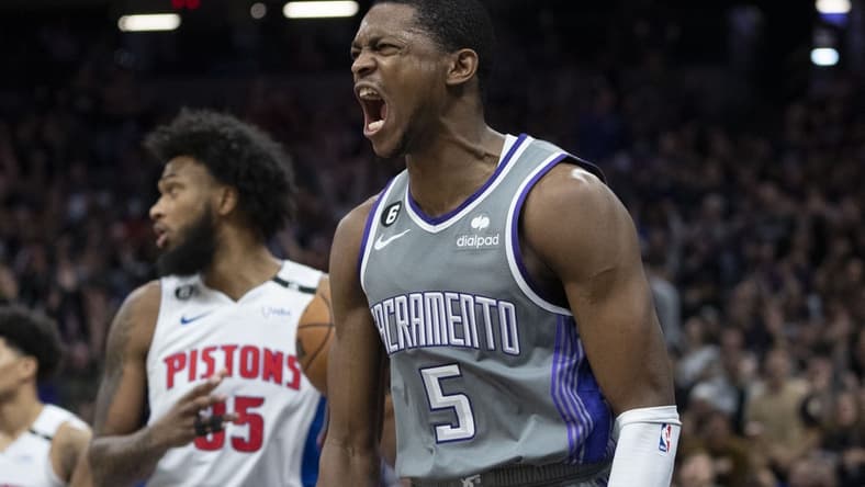 November 20, 2022; Sacramento, California, USA; Sacramento Kings guard De'Aaron Fox (5) celebrates after dunking the basketball against Detroit Pistons forward Marvin Bagley III (35) during the fourth quarter at Golden 1 Center. Mandatory Credit: Kyle Terada-USA TODAY Sports