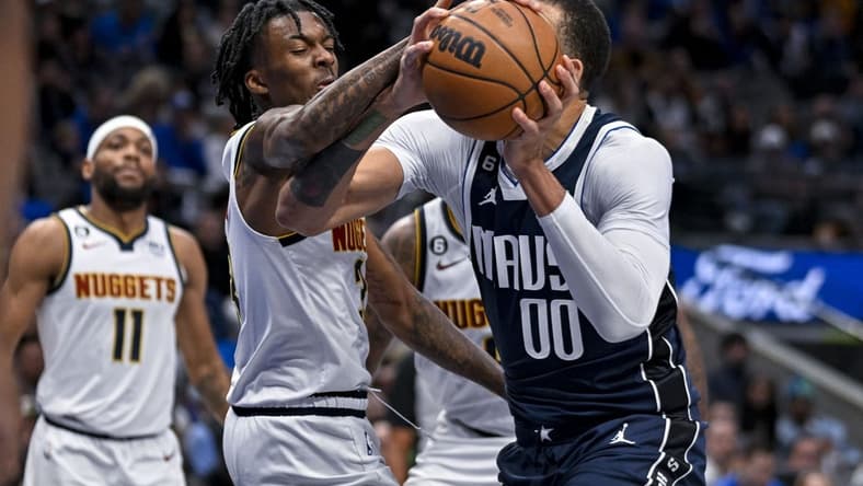 Nov 20, 2022; Dallas, Texas, USA; Dallas Mavericks center JaVale McGee (00) is fouled by Denver Nuggets guard Bones Hyland (3) during the second quarter at the American Airlines Center. Mandatory Credit: Jerome Miron-USA TODAY Sports