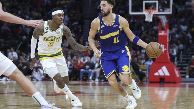 Nov 20, 2022; Houston, Texas, USA; Golden State Warriors guard Klay Thompson (11) dribbles the ball as Houston Rockets guard Kevin Porter Jr. (3) defends during the fourth quarter at Toyota Center. Mandatory Credit: Troy Taormina-USA TODAY Sports