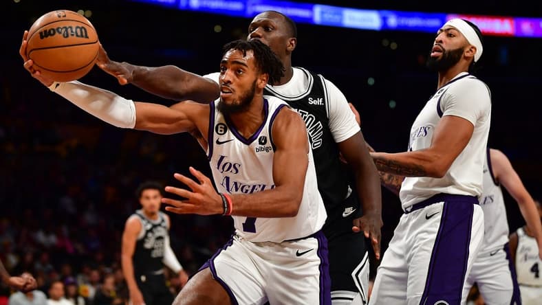 Nov 20, 2022; Los Angeles, California, USA; Los Angeles Lakers forward Troy Brown Jr. (7) plays for the rebound againt San Antonio Spurs center Gorgui Dieng (41) during the first half at Crypto.com Arena. Mandatory Credit: Gary A. Vasquez-USA TODAY Sports