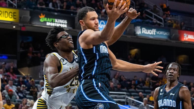 Nov 21, 2022; Indianapolis, Indiana, USA; Orlando Magic guard Jalen Suggs (4) rebounds the ball while Indiana Pacers forward Jalen Smith (25) defends in the first quarter at Gainbridge Fieldhouse. Mandatory Credit: Trevor Ruszkowski-USA TODAY Sports