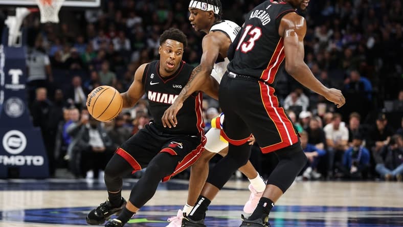 Nov 21, 2022; Minneapolis, Minnesota, USA; Miami Heat guard Kyle Lowry (7) dribbles the ball while Minnesota Timberwolves forward Jaden McDaniels (3) defends during the first quarter at Target Center. Mandatory Credit: Matt Krohn-USA TODAY Sports