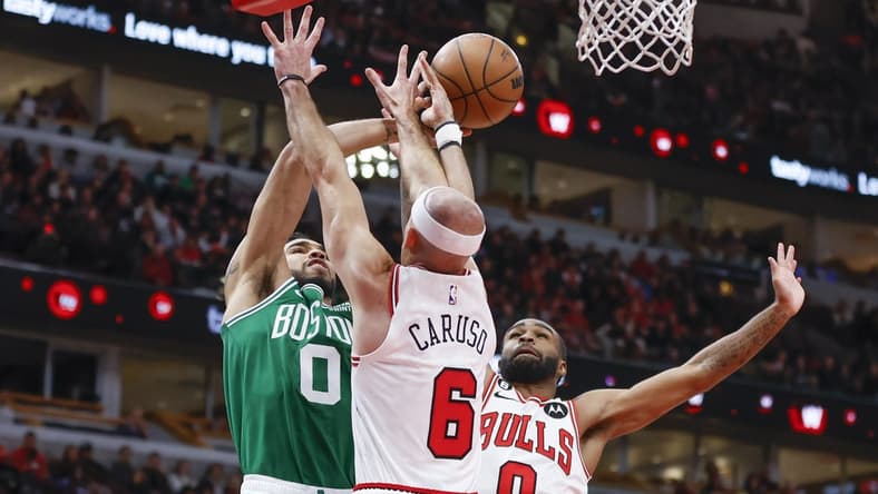 Nov 21, 2022; Chicago, Illinois, USA; Boston Celtics forward Jayson Tatum (0) is defended by Chicago Bulls guard Alex Caruso (6) and guard Coby White (0) during the second half at United Center. Mandatory Credit: Kamil Krzaczynski-USA TODAY Sports