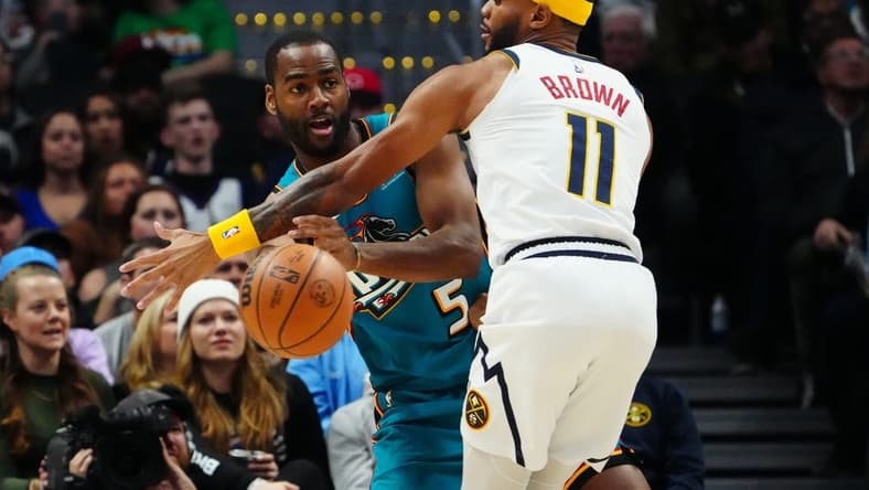Nov 22, 2022; Denver, Colorado, USA; Detroit Pistons guard Alec Burks (5) passes the ball around Denver Nuggets forward Bruce Brown (11) in the second quarter at Ball Arena. Mandatory Credit: Ron Chenoy-USA TODAY Sports
