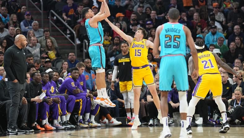 Nov 22, 2022; Phoenix, Arizona, USA; Phoenix Suns guard Devin Booker (1) shoots over Los Angeles Lakers guard Austin Reaves (15) during the first half at Footprint Center. Mandatory Credit: Joe Camporeale-USA TODAY Sports