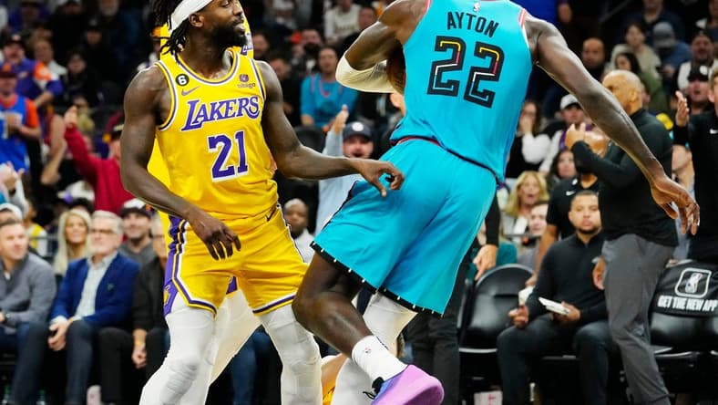 Nov 22, 2022; Phoenix, AZ, USA; Los Angeles Lakers guard Patrick Beverley (21) pushes Phoenix Suns center Deandre Ayton (22) to the court in the second half at Footprint Center. Beverley was ejected from the game. Mandatory Credit: Rob Schumacher-Arizona Republic
