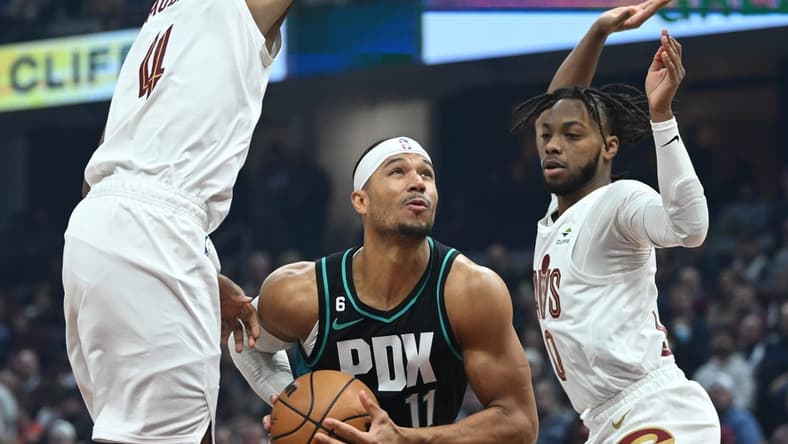 Nov 23, 2022; Cleveland, Ohio, USA; Portland Trail Blazers guard Josh Hart (11) drives to the basket between Cleveland Cavaliers forward Evan Mobley (4) and guard Darius Garland (10) during the first half at Rocket Mortgage FieldHouse. Mandatory Credit: Ken Blaze-USA TODAY Sports