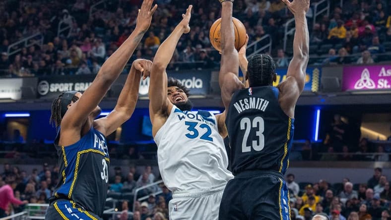 Nov 23, 2022; Indianapolis, Indiana, USA; Minnesota Timberwolves center Karl-Anthony Towns (32) shoots the ball while Indiana Pacers forward Aaron Nesmith (23) defends in the second quarter at Gainbridge Fieldhouse. Mandatory Credit: Trevor Ruszkowski-USA TODAY Sports