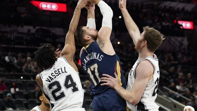 Nov 23, 2022; San Antonio, Texas, USA; New Orleans Pelicans center Jonas Valanciunas (17) shoots over San Antonio Spurs guard Devin Vassell (24) and center Jakob Poeltl (25) during the first half at AT&T Center. Mandatory Credit: Scott Wachter-USA TODAY Sports