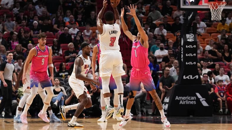 Nov 23, 2022; Miami, Florida, USA; Miami Heat guard Kyle Lowry (7) attempts a three point shot over Washington Wizards guard Johnny Davis (1) during the first half at FTX Arena. Mandatory Credit: Jasen Vinlove-USA TODAY Sports