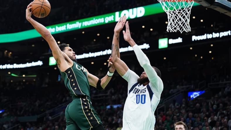 Nov 23, 2022; Boston, Massachusetts, USA; Boston Celtics forward Jayson Tatum (0) drives to the basket against Dallas Mavericks center JaVale McGee (00) in the second quarter at TD Garden. Mandatory Credit: David Butler II-USA TODAY Sports