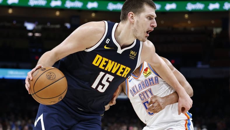 Nov 23, 2022; Oklahoma City, Oklahoma, USA; Denver Nuggets center Nikola Jokic (15) drives to the basket against Oklahoma City Thunder forward Darius Bazley (55) during the second quarter at Paycom Center. Mandatory Credit: Alonzo Adams-USA TODAY Sports