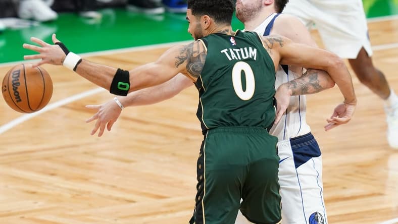Nov 23, 2022; Boston, Massachusetts, USA; Dallas Mavericks guard Luka Doncic (77) works for the ball against Boston Celtics forward Jayson Tatum (0) in the fourth quarter at TD Garden. Mandatory Credit: David Butler II-USA TODAY Sports