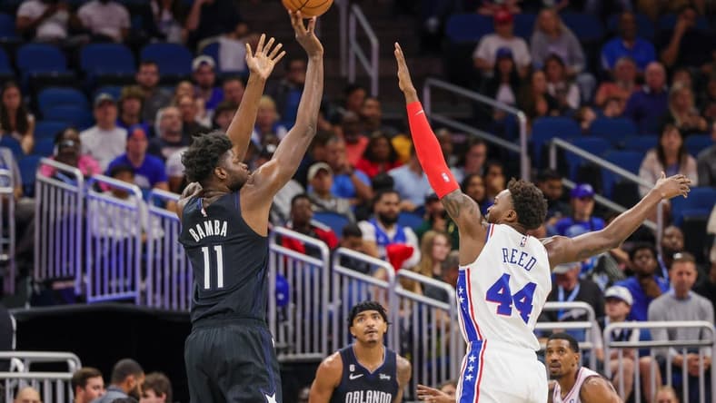 Nov 25, 2022; Orlando, Florida, USA; Orlando Magic center Mo Bamba (11) shoots the ball over Philadelphia 76ers forward Paul Reed (44) during the first quarter at Amway Center. Mandatory Credit: Mike Watters-USA TODAY Sports