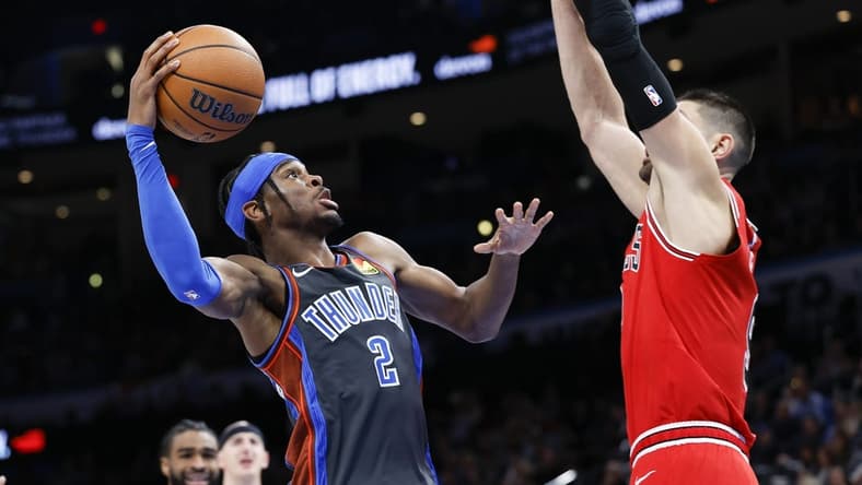 Nov 25, 2022; Oklahoma City, Oklahoma, USA; Oklahoma City Thunder guard Shai Gilgeous-Alexander (2) is defended by Chicago Bulls center Nikola Vucevic (9) on a drive during the second quarter at Paycom Center. Mandatory Credit: Alonzo Adams-USA TODAY Sports