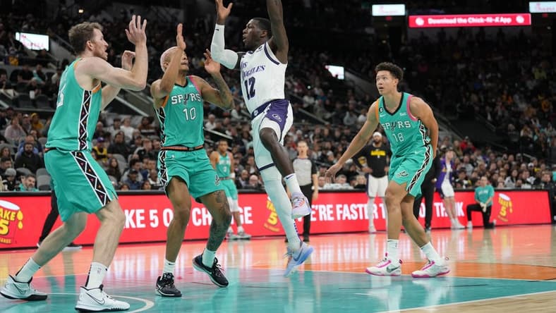 Nov 25, 2022; San Antonio, Texas, USA; Los Angeles Lakers guard Kendrick Nunn (12) passes the ball over San Antonio Spurs forward Jeremy Sochan (10) in the first half at the AT&T Center. Mandatory Credit: Daniel Dunn-USA TODAY Sports