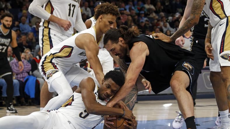 Nov 25, 2022; Memphis, Tennessee, USA; New Orleans Pelicans guard Dyson Daniels (11) forward Herbert Jones (5) and Memphis Grizzlies center Steven Adams (4) battle for a loose ball during the first half at FedExForum. Mandatory Credit: Petre Thomas-USA TODAY Sports
