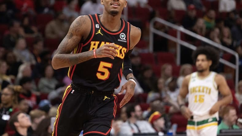 Nov 25, 2022; Houston, Texas, USA; Atlanta Hawks guard Dejounte Murray (5) celebrates his three point basket against the Houston Rockets in the second quarter at Toyota Center. Mandatory Credit: Thomas Shea-USA TODAY Sports