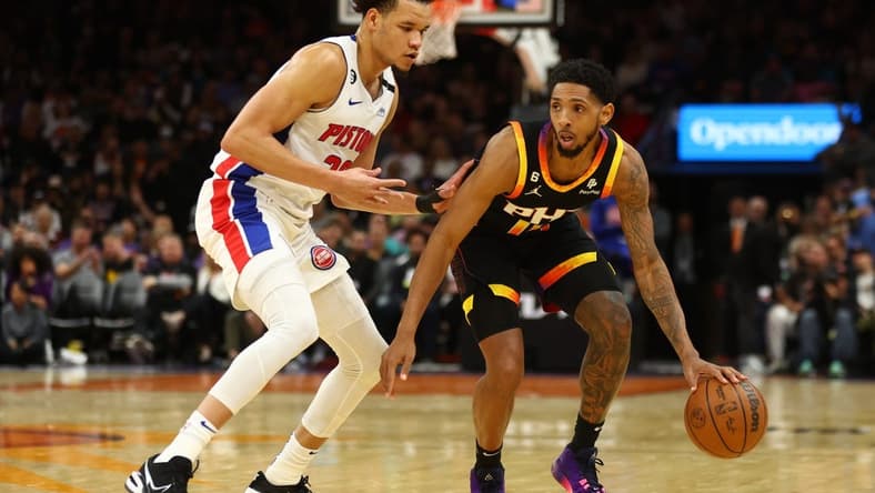 Nov 25, 2022; Phoenix, Arizona, USA; Phoenix Suns guard Cameron Payne (15) moves the ball against Detroit Pistons forward Kevin Knox II in the first half at Footprint Center. Mandatory Credit: Mark J. Rebilas-USA TODAY Sports
