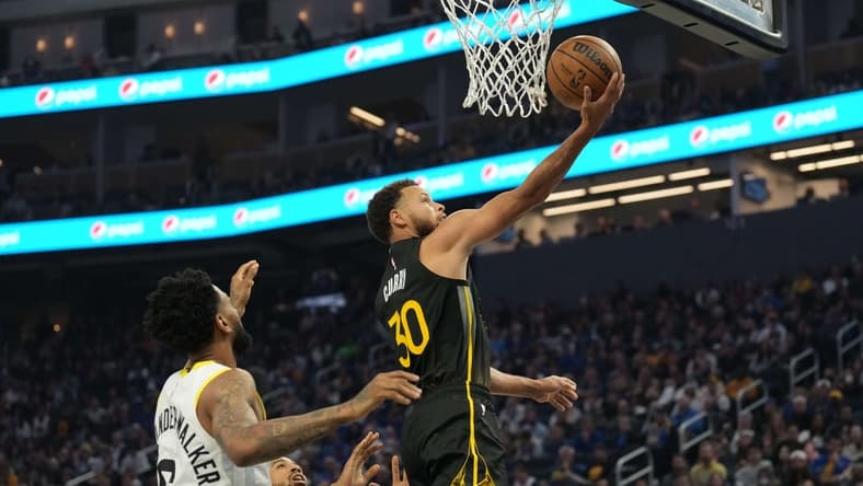Nov 25, 2022; San Francisco, California, USA; Golden State Warriors guard Stephen Curry (30) shoots against Utah Jazz guards Nickeil Alexander-Walker (6) and Talen Horton-Tucker (0) during the first quarter at Chase Center. Mandatory Credit: Darren Yamashita-USA TODAY Sports