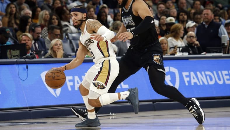 Nov 25, 2022; Memphis, Tennessee, USA; New Orleans Pelicans guard Jose Alvarado (15) dribbles up the court as Memphis Grizzlies forward David Roddy (27) defends during the second half at FedExForum. Mandatory Credit: Petre Thomas-USA TODAY Sports