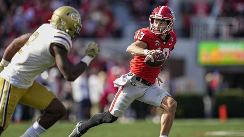 Nov 26, 2022; Athens, Georgia, USA; Georgia Bulldogs quarterback Stetson Bennett (13) runs with the ball against the Georgia Tech Yellow Jackets during the first quarter at Sanford Stadium. Mandatory Credit: Dale Zanine-USA TODAY Sports