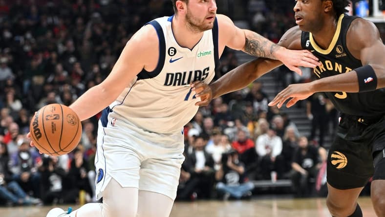Nov 26, 2022; Toronto, Ontario, CAN; Dallas Mavericks guard Luka Doncic (77) tries to dribble the ball past Toronto Raptors forward OG Anunoby (3) in the first half at Scotiabank Arena. Mandatory Credit: Dan Hamilton-USA TODAY Sports