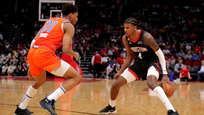 Nov 26, 2022; Houston, Texas, USA; Houston Rockets guard Jalen Green (4) handles the ball while Oklahoma City Thunder guard Aaron Wiggins (21) defends during the second quarter at Toyota Center. Mandatory Credit: Erik Williams-USA TODAY Sports